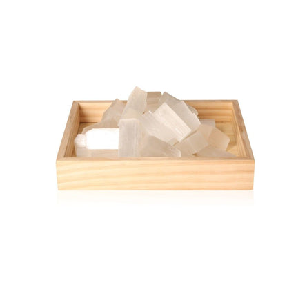 Wooden tray displaying raw Selenite crystals for sale, known for their purity and spiritual benefits.