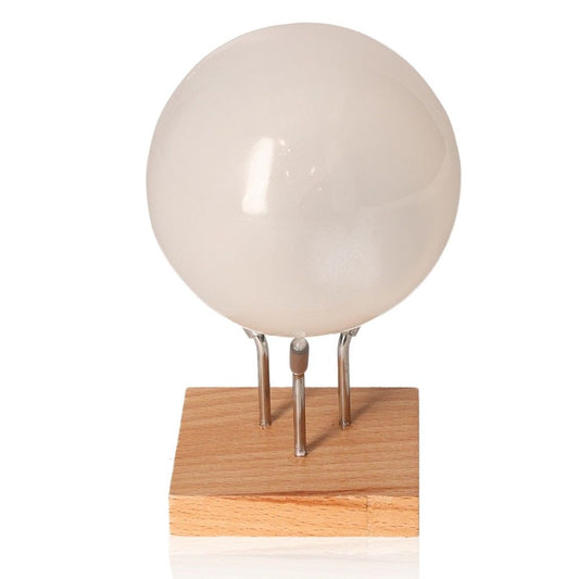 Selenite sphere on wooden stand, 8cm, by Sylvia Crystals, symbolizing purity and spiritual growth, ethically sourced and high-quality.