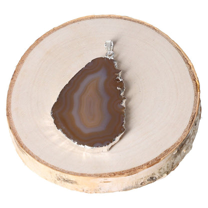 Agate slice natural pendant with metal plating on wood slice background