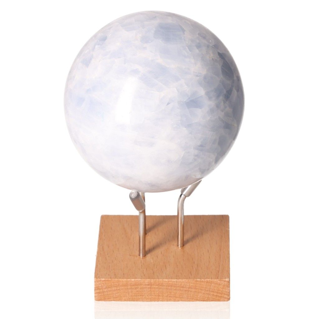 Blue Calcite Sphere on wooden stand, showcasing serene soft blue hues for calm, communication, and emotional healing.