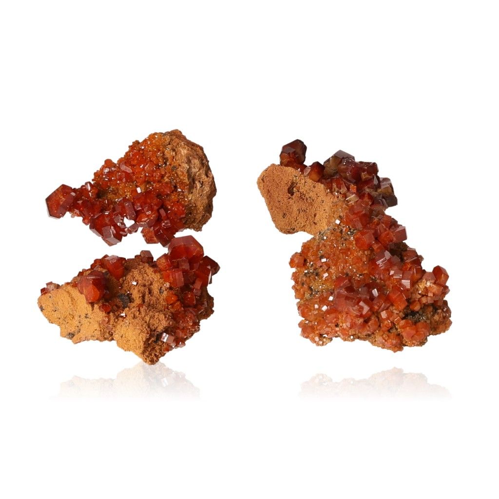 Vanadinite druzy clusters with vibrant reddish-orange hexagonal crystals on a glassy surface, enhancing focus and motivation.