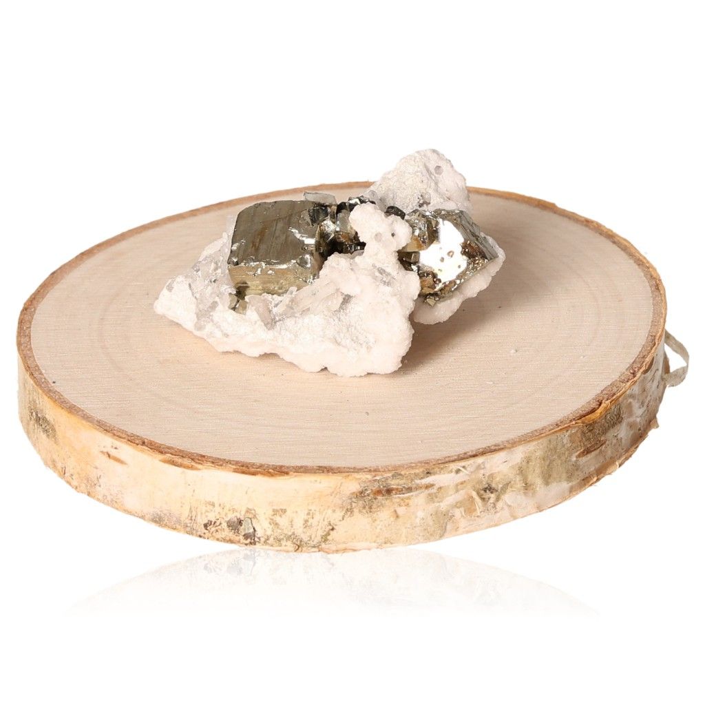 Pyrite druze gemstone on a wooden slab, promoting independence and courage for goal achievement.