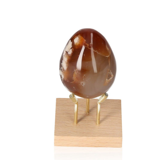 Flower Agate Egg with unique floral patterns on a stand, showcasing its beauty and energy harmonization benefits.