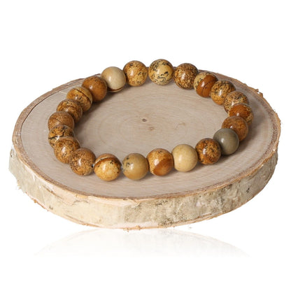 Natural Jasper 8mm beaded bracelet on a wooden display, featuring earthy tones and a smooth, polished finish.