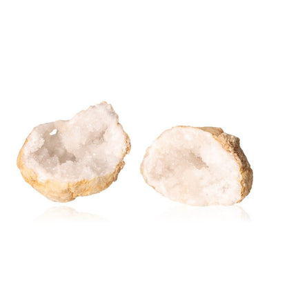 Milky quartz geodes with white crystals, showcasing rugged outer shell and sparkling interior, enhancing tranquility and energy balance.