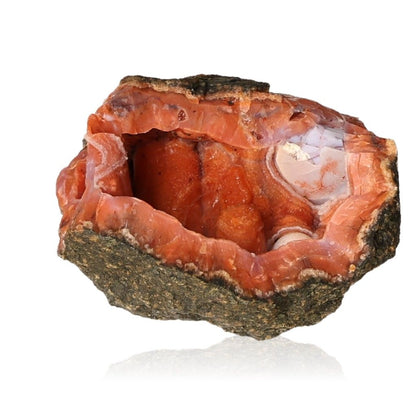 Vibrant orange calcite stalactite showcasing intricate layers and earthy tones.