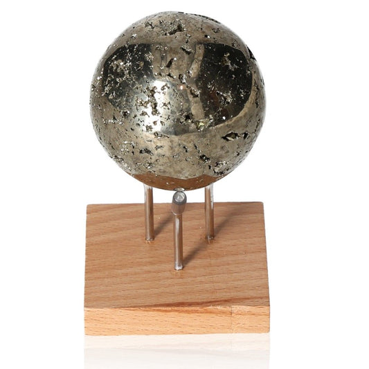 Pyrite sphere on a wooden stand, promoting independence and courage with its metallic luster. Ideal for inspiration and motivation.