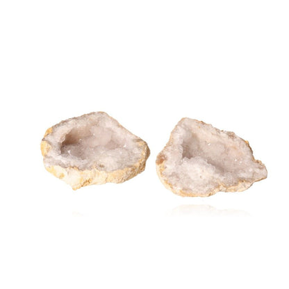 Quartz geode halves showcasing sparkling milky white crystals and rugged outer shell, ideal for energy balance and tranquility.