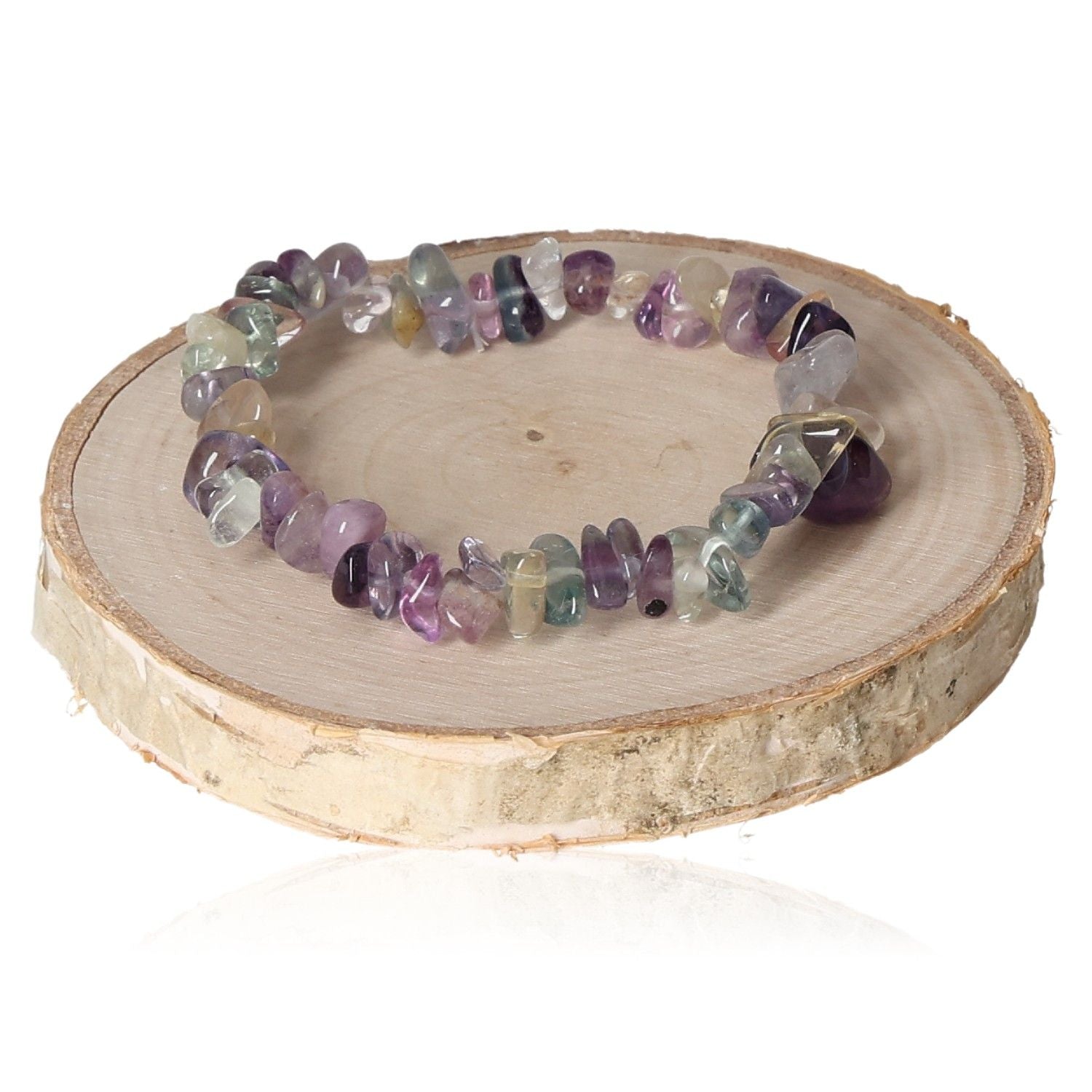 Vibrant fluorite rainbow bracelet chips displayed on a wooden stand.