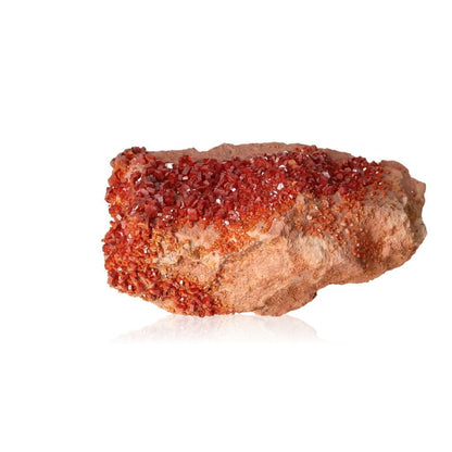 Red vanadinite druzy stone for focus and motivation on white background.