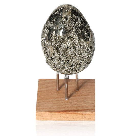 Sparkling pyrite egg on a wooden stand, promoting courage and independence. Perfect for goal achievement and new ideas.