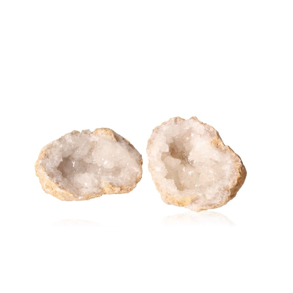 Quartz geode halves showcasing milky, sparkling crystals inside rugged outer shells, enhancing tranquility and energy balance.