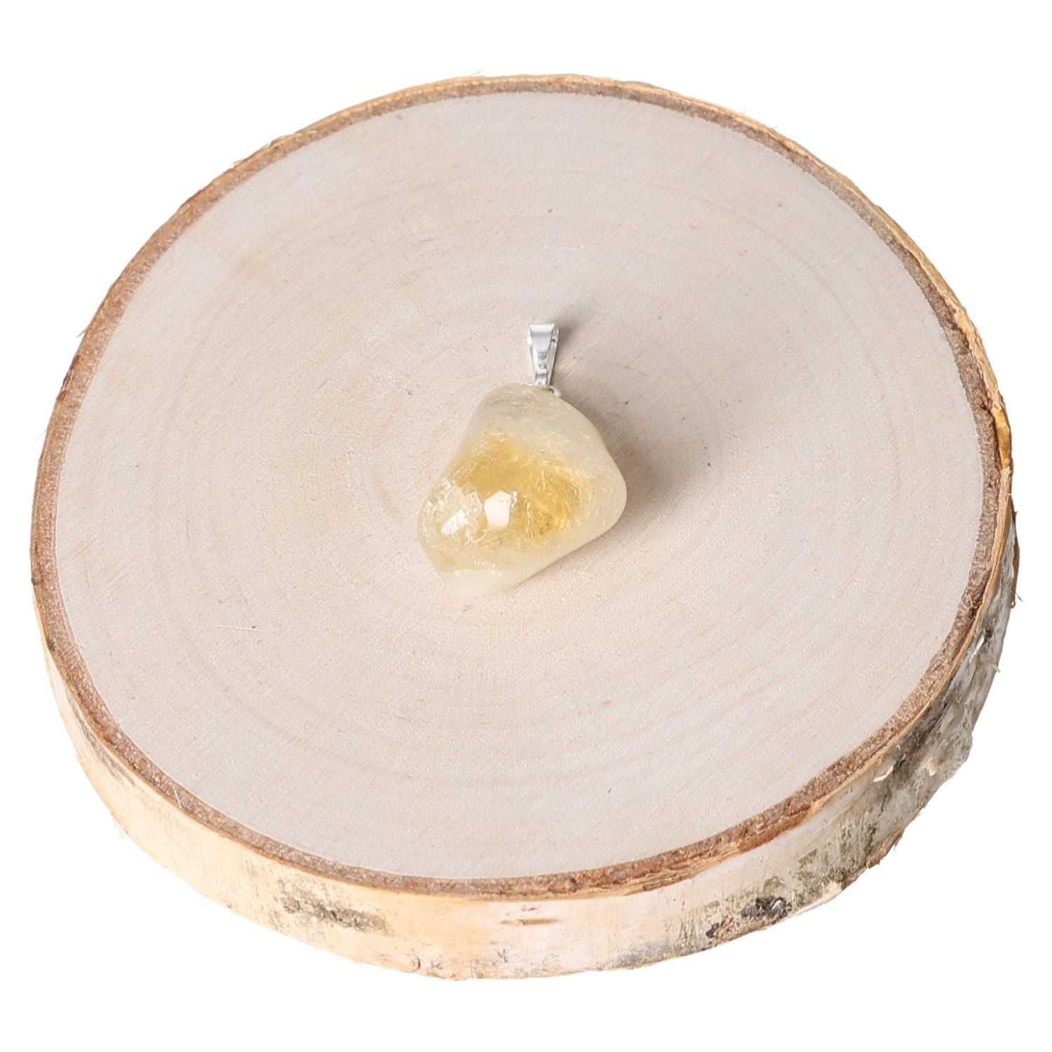 Citrine tumbled pendant displayed on a round wooden slab for a natural look.