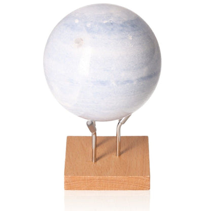 Blue Calcite Sphere for stress relief, communication, and emotional healing on a wooden stand