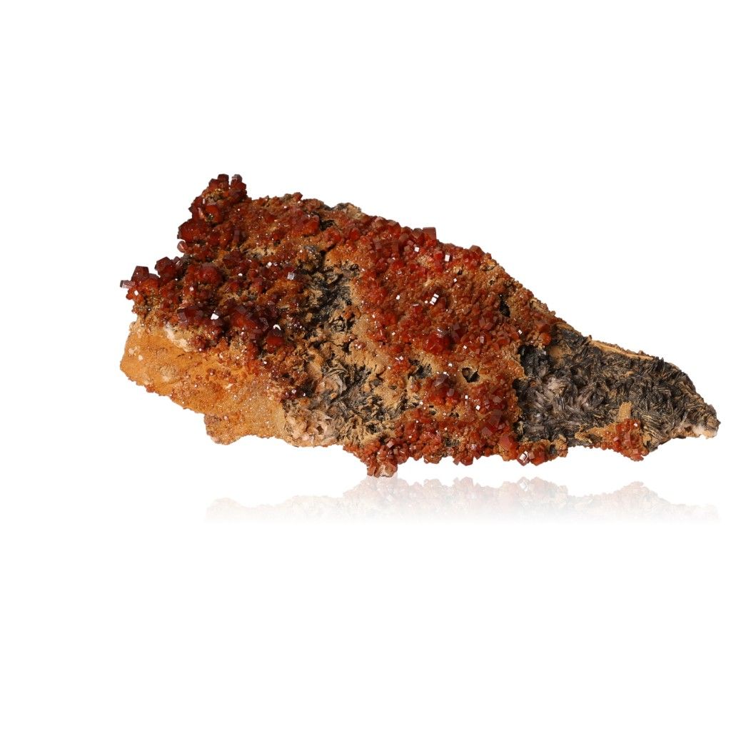 Vanadinite druzy stone with vibrant reddish-brown hexagonal crystals on a glassy surface, ideal for enhancing focus and motivation.