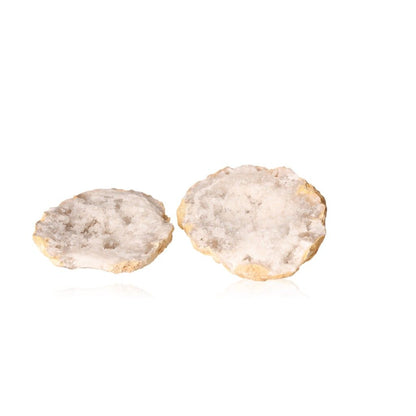 Milky quartz geodes showcasing rugged exterior and sparkling white crystals for energy cleansing and tranquility.