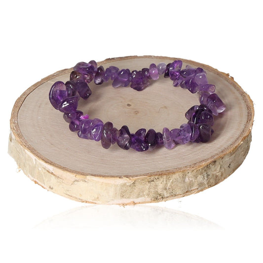 Amethyst bracelet chips on a wooden stand showcasing vibrant purple gemstones for elegant jewelry styling.