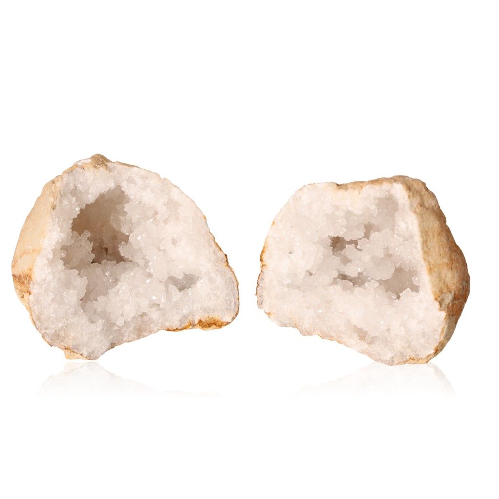 Two halves of a milky quartz geode with sparkling white crystals, showcasing a rugged earthy exterior and promoting tranquility and clarity.