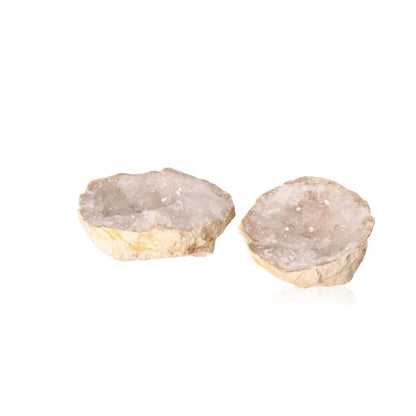 Quartz geodes showcasing sparkling cloudy white crystals, known for purifying energy and enhancing tranquility and focus.