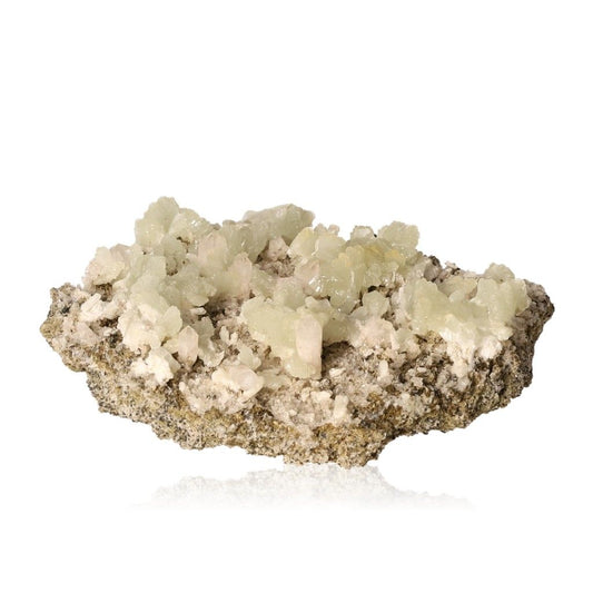 Translucent pale green Prehnite crystal cluster on rock base displaying its soothing and calming properties.