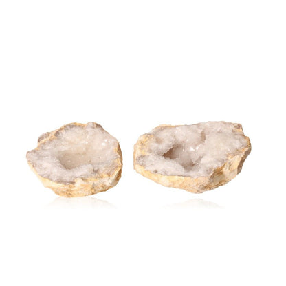 Quartz geode with rugged exterior and sparkling white crystals, known for purifying energy and promoting tranquility and clarity.