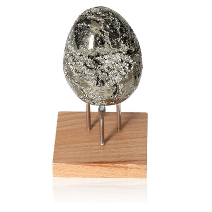 Shimmering pyrite egg on a wooden stand, ideal for fostering independence and inspiring new ideas.