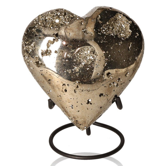 Heart-shaped pyrite stone on a stand, known for promoting independence, courage, and generating new ideas.