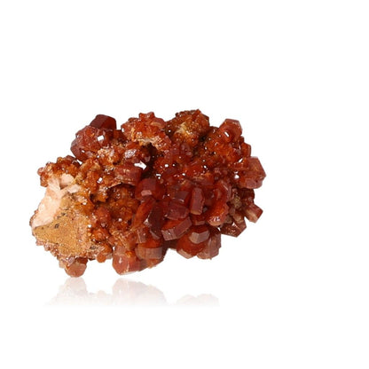 Vanadinite druzy with hexagonal crystals, showcasing reddish-brown hues and a glassy surface for motivation and transformation.