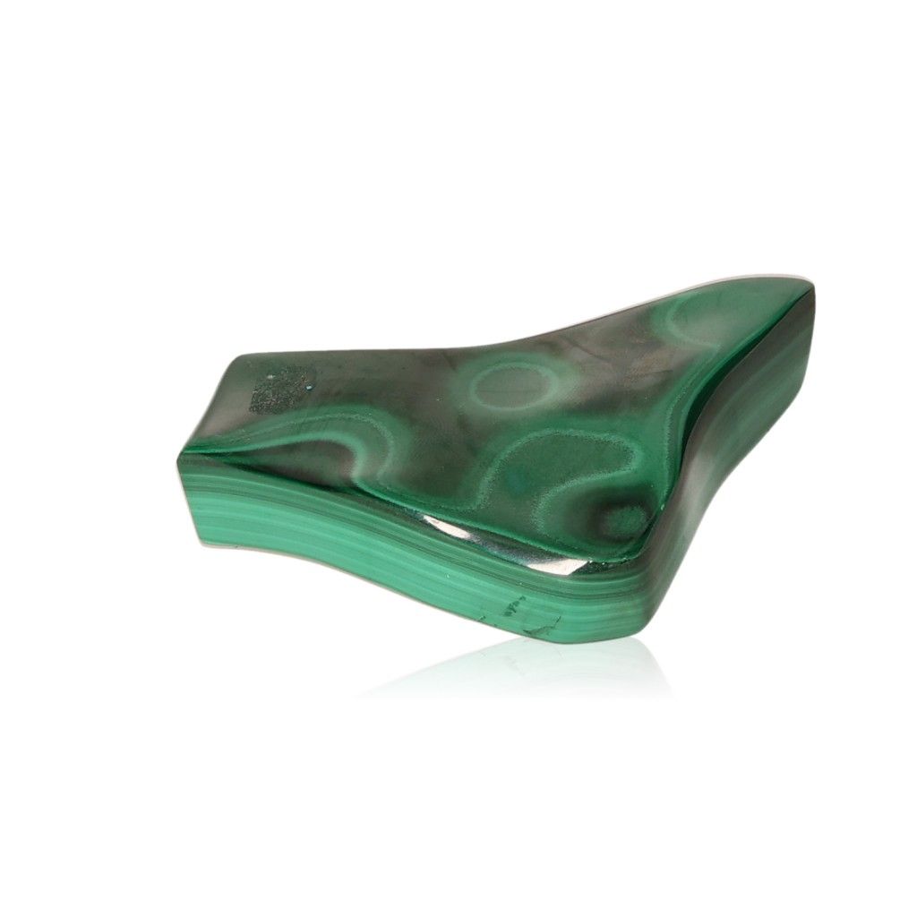 Polished malachite gemstone with distinctive green bands, symbolizing courage and harmony.