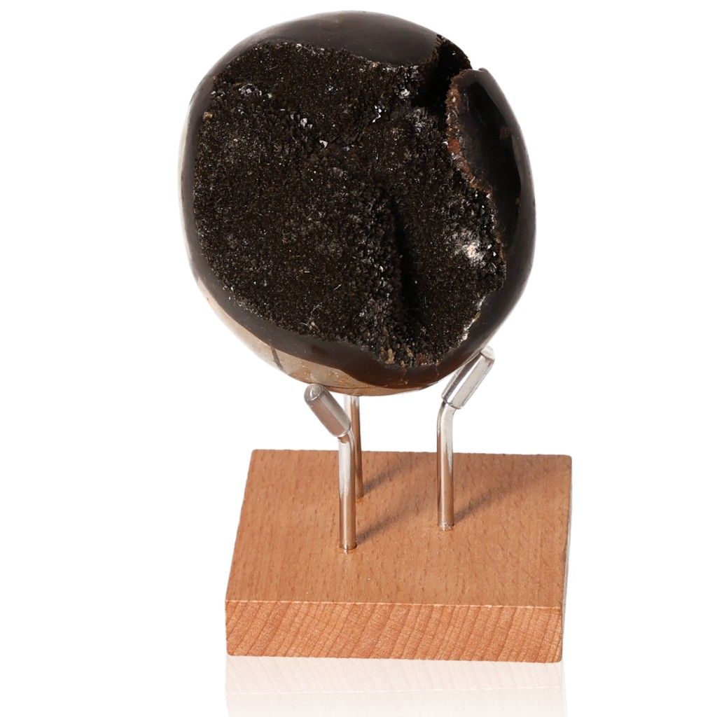 Septarian "Dragon Stone" mineral on wooden stand showcasing unique texture and symbolism of power and endurance.