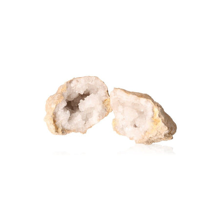 Quartz geode split open showing milky white crystals, purifying energy, and earthy exterior for tranquility and focus.