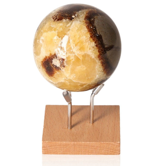 Septarian Sphere on wooden stand, showcasing unique colors and patterns, symbolizing power and endurance.