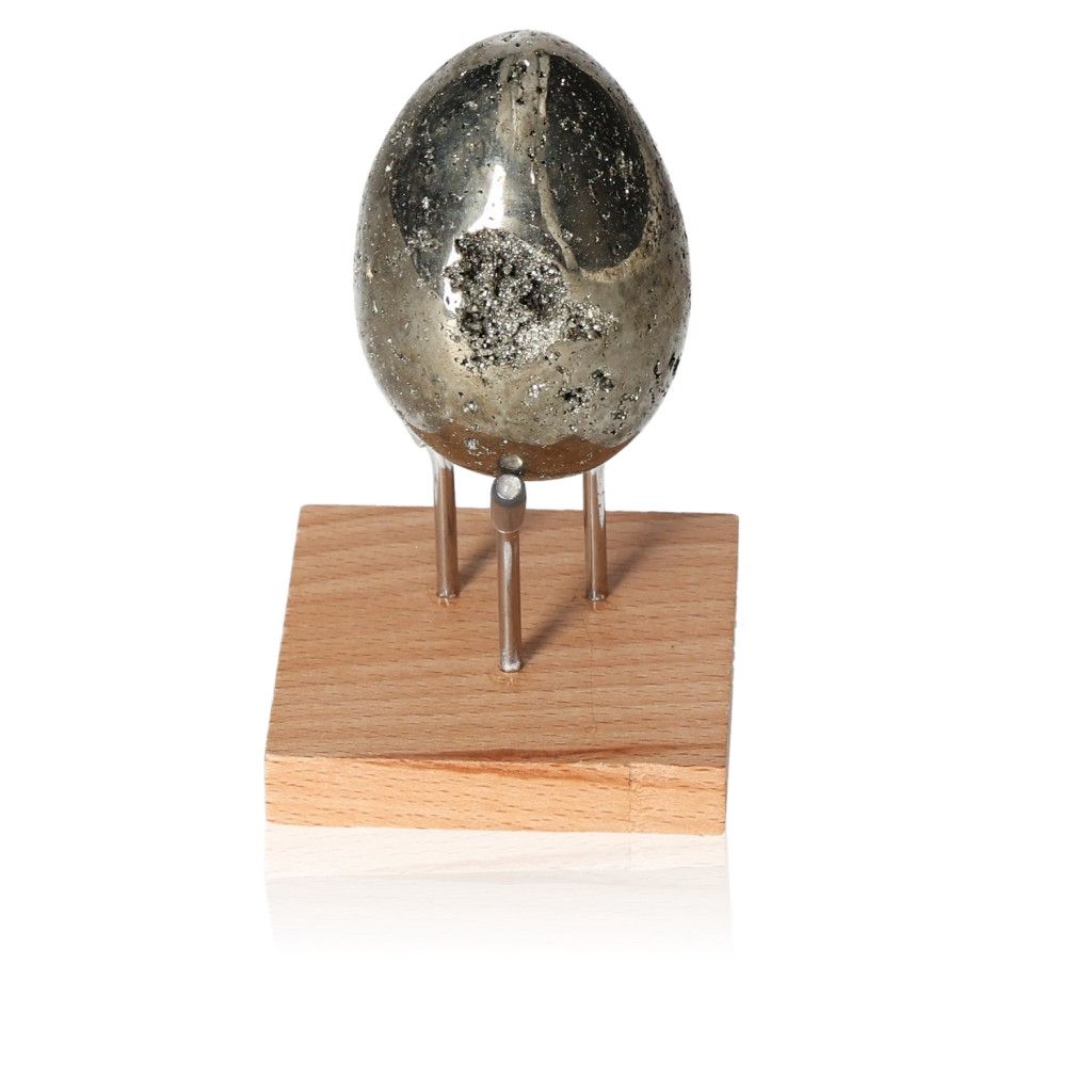 Pyrite egg on a wooden stand, promoting mental independence and inspiring new ideas.