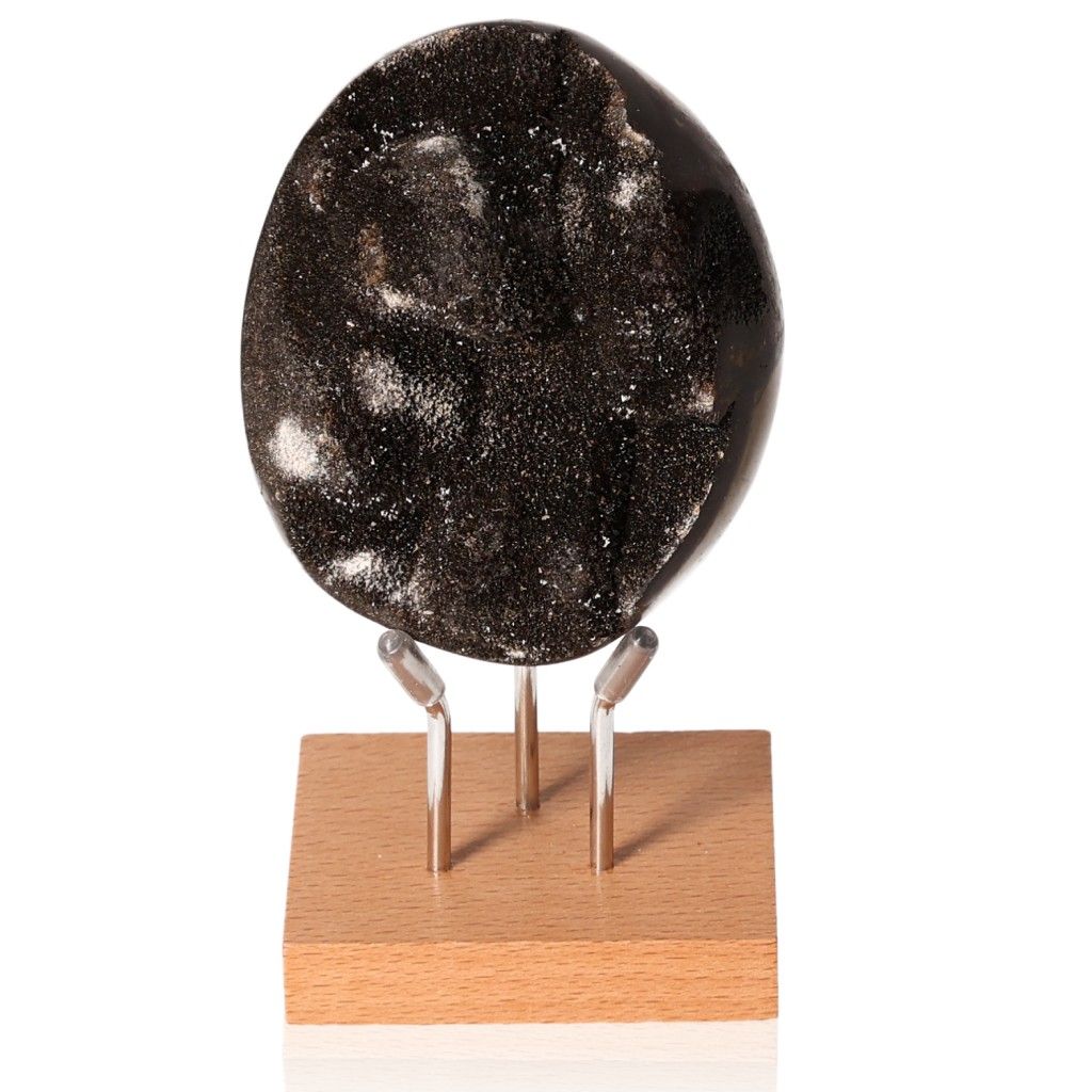 Shiny black Septarian stone displayed on a wooden stand