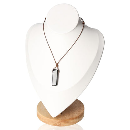 Boho necklace featuring an obsidian pendant displayed on a stand, showcasing bohemian style and spiritual protection.