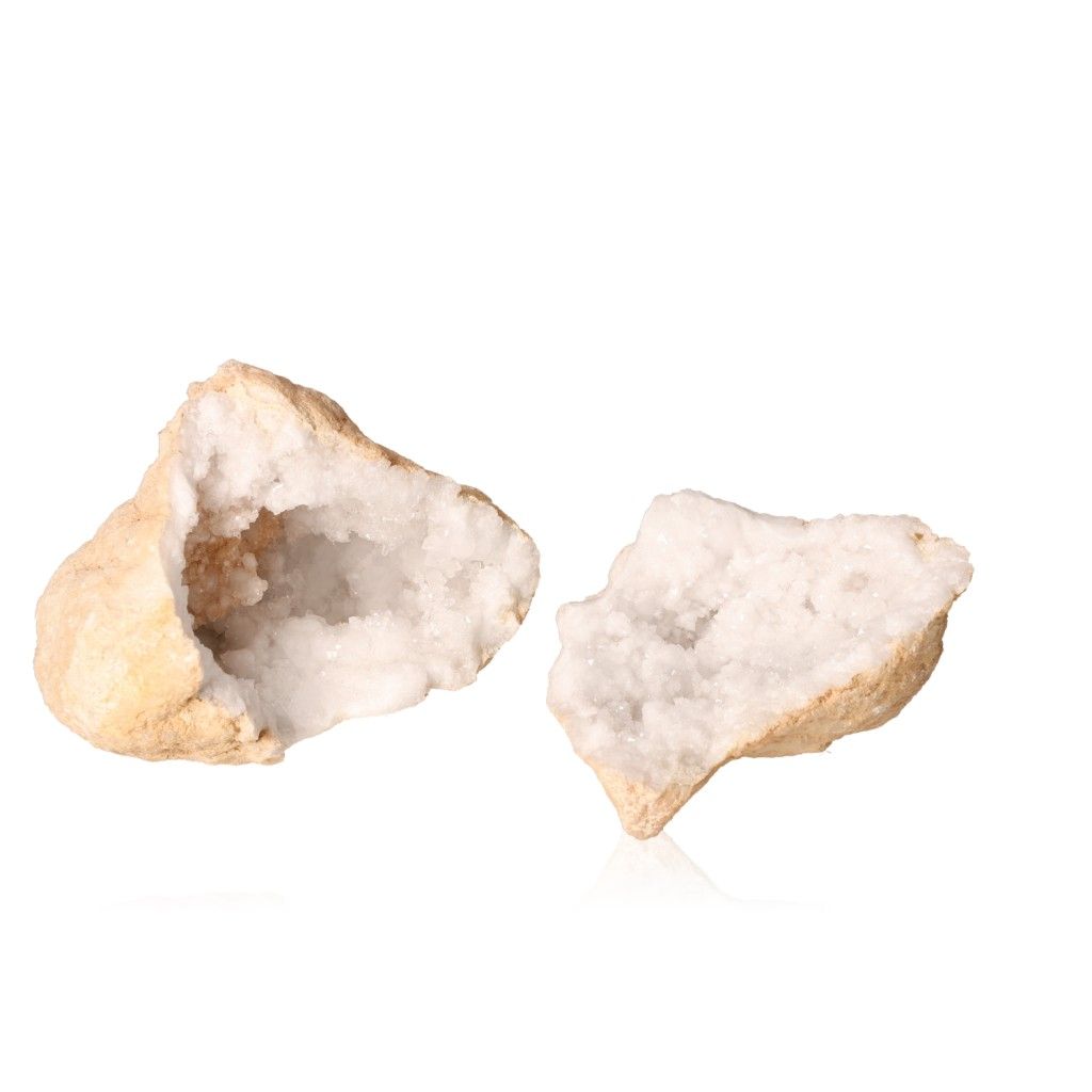 Milky quartz geodes with rugged shells revealing sparkling white crystals, known for purifying energy and promoting tranquility.