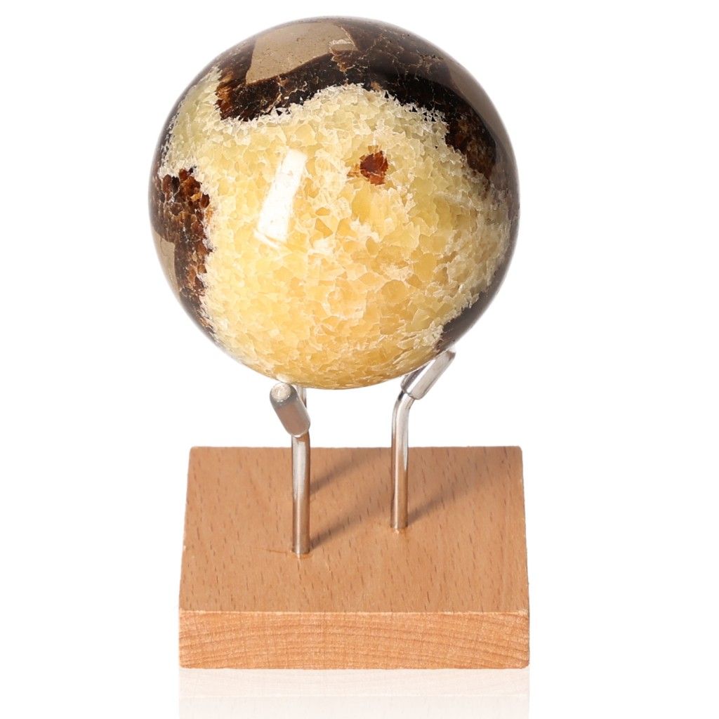 Septarian sphere on wooden stand, showcasing unique patterns and colors, symbolizing power and endurance.