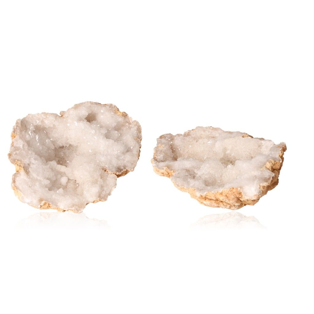 Milky quartz geodes with sparkling white crystals and earthy outer shell, ideal for enhancing tranquility and balance.