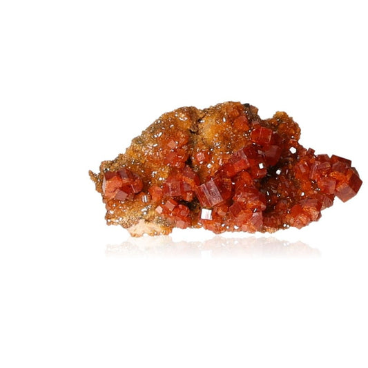 Vanadinite Druze with vibrant reddish-brown hexagonal crystals on a glassy surface, enhancing focus and motivation.