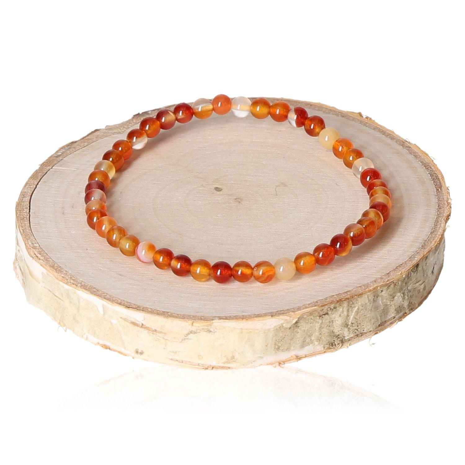 Elegant 4mm carnelian bracelet with vibrant orange beads, displayed on a wooden stand for jewelry lovers.