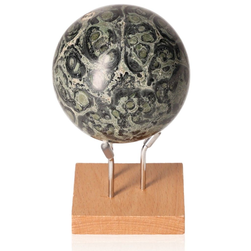 Kambaba Jasper Sphere on wooden stand, showcasing its green and black patterns, ideal for promoting peace and grounding energy.