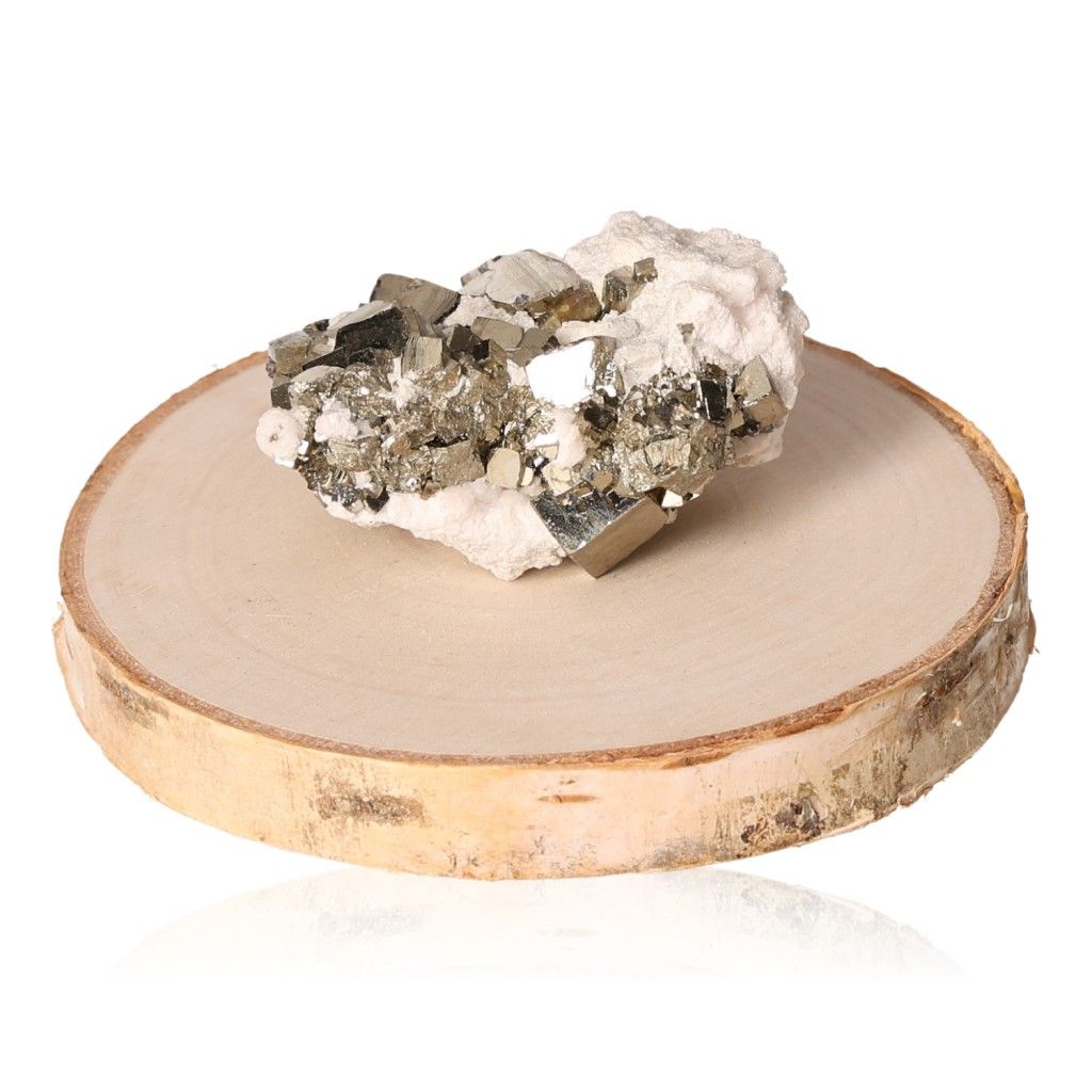 Pyrite druzy crystal on wooden slab, inspiring independence and courage for goal achievement.